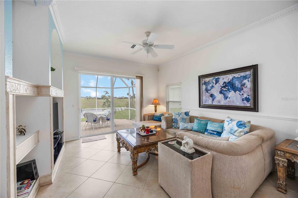48 Bunker Road Rotonda West, FL 33947 - Photo 15 of 59 a living room with furniture a large window with a dining table and chairs