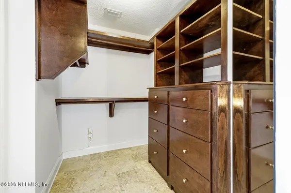 a bedroom with a bed and a table in it