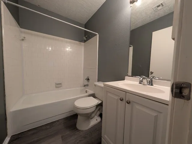 a bathroom with a sink toilet a bathtub and vanity