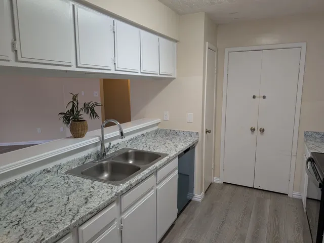 a kitchen with a sink and cabinets