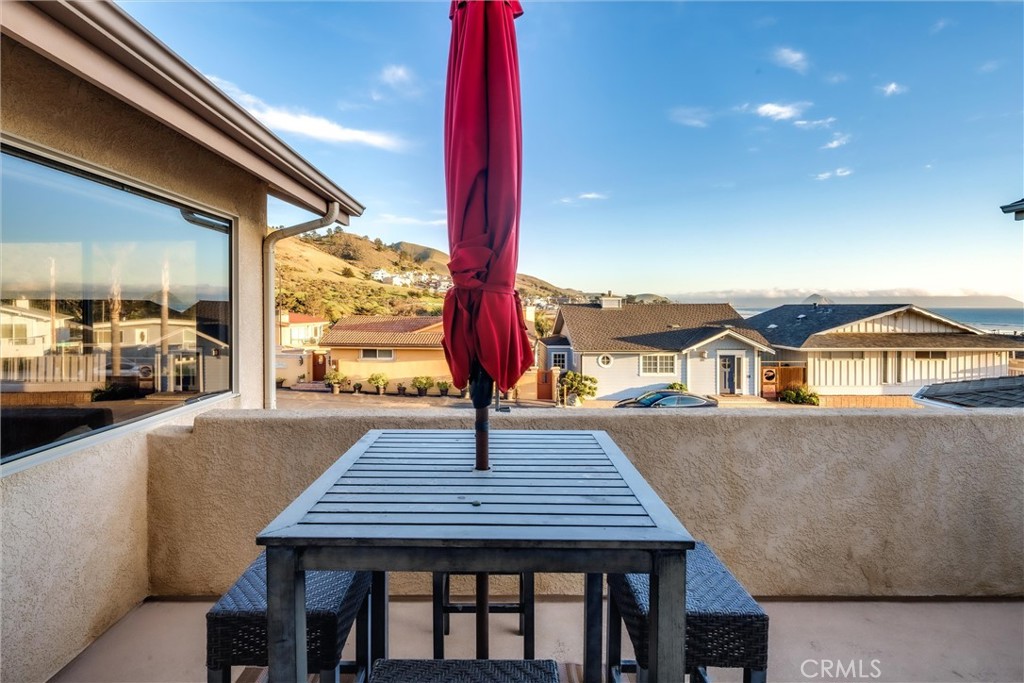 33 23rd Street Cayucos, CA 93430 - Photo 12 of 31 a view of a patio with table and chairs with wooden floor and fence