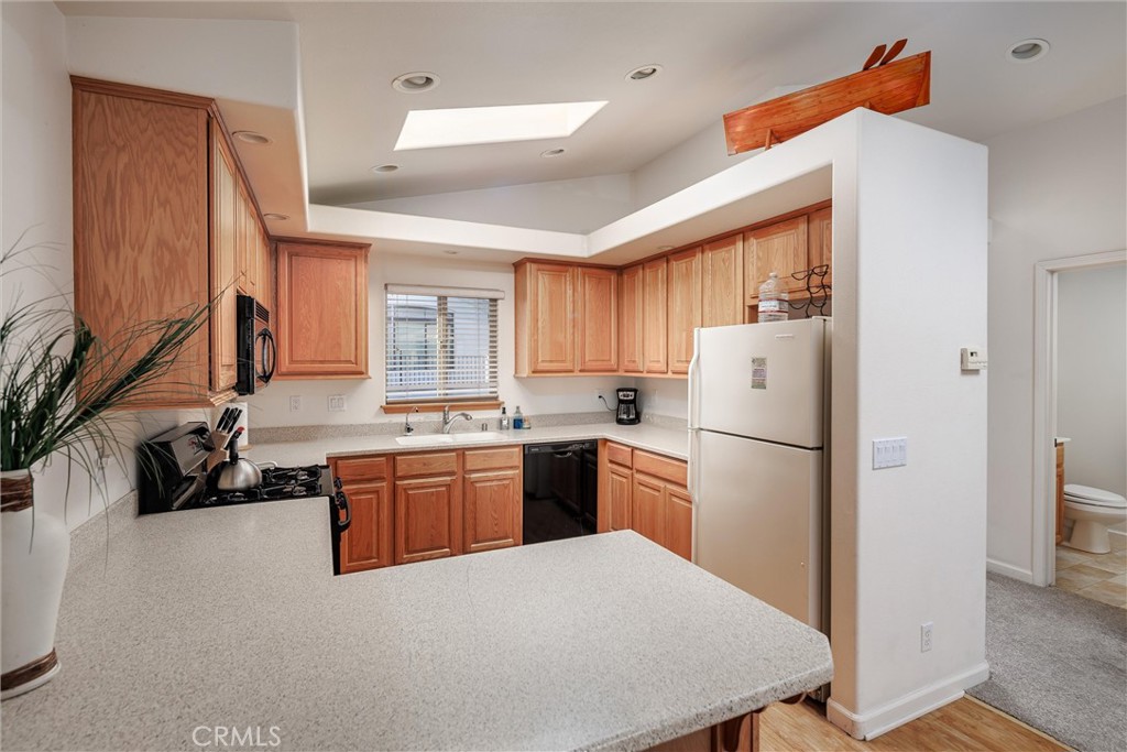 33 23rd Street Cayucos, CA 93430 - Photo 16 of 31 a kitchen with refrigerator a sink a stove and cabinets