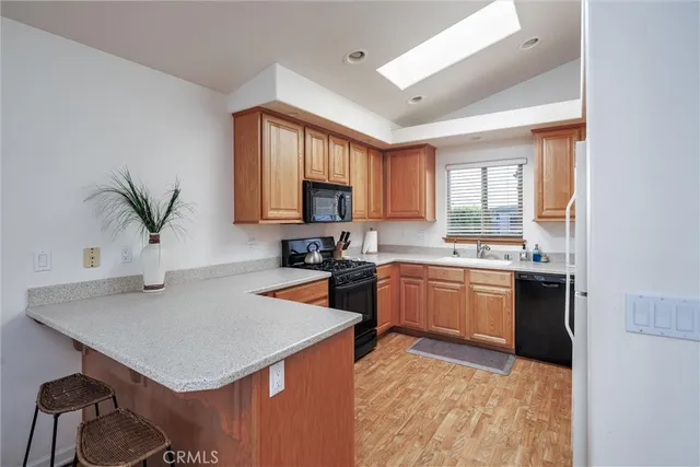 a kitchen with a refrigerator a stove a sink and a oven