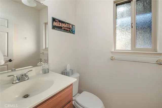 a bathroom with a sink a toilet and mirror