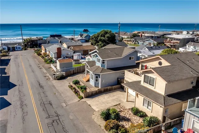 an aerial view of a house with large trees