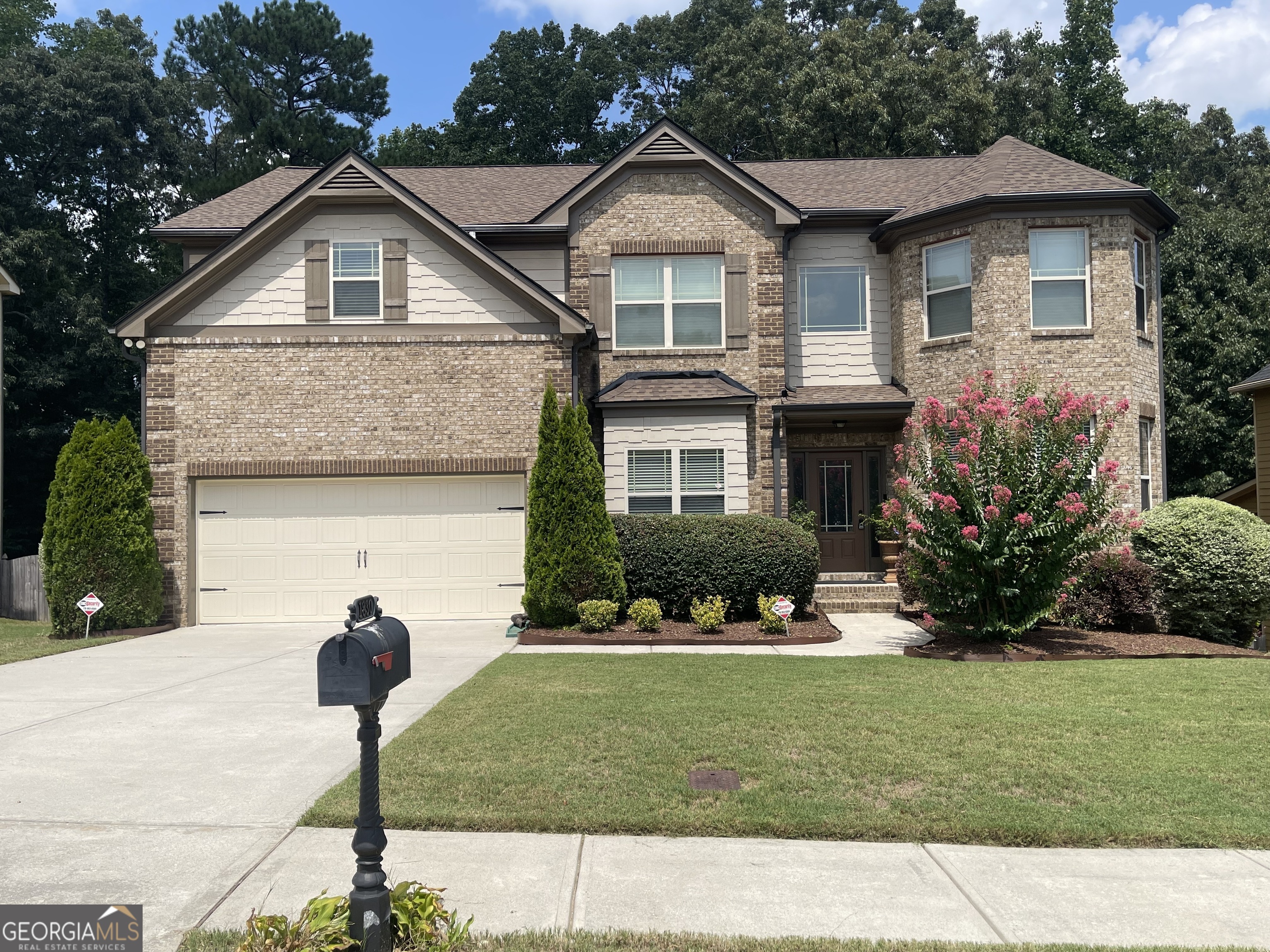 1830 Alder Tree Way Dacula, GA 30019 - Photo 1 of 1 a front view of a house with a yard and garage