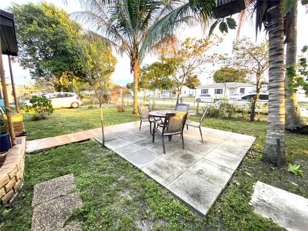 a view of a backyard with sitting area