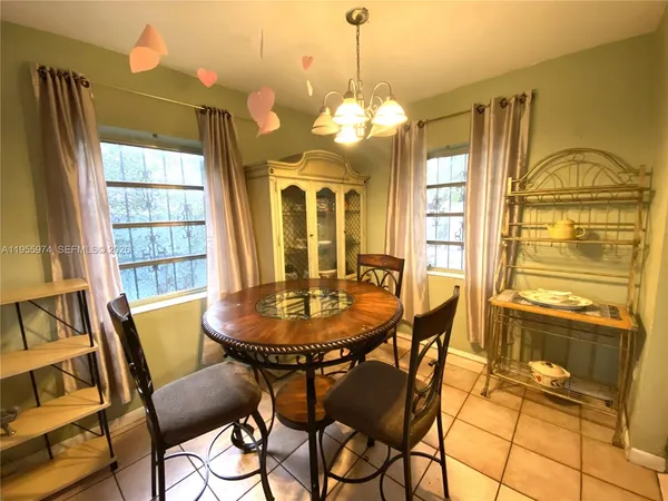 a view of a dining room with furniture and a chandelier