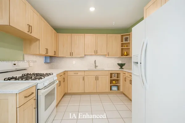 a kitchen with stainless steel appliances granite countertop a stove a sink and a refrigerator