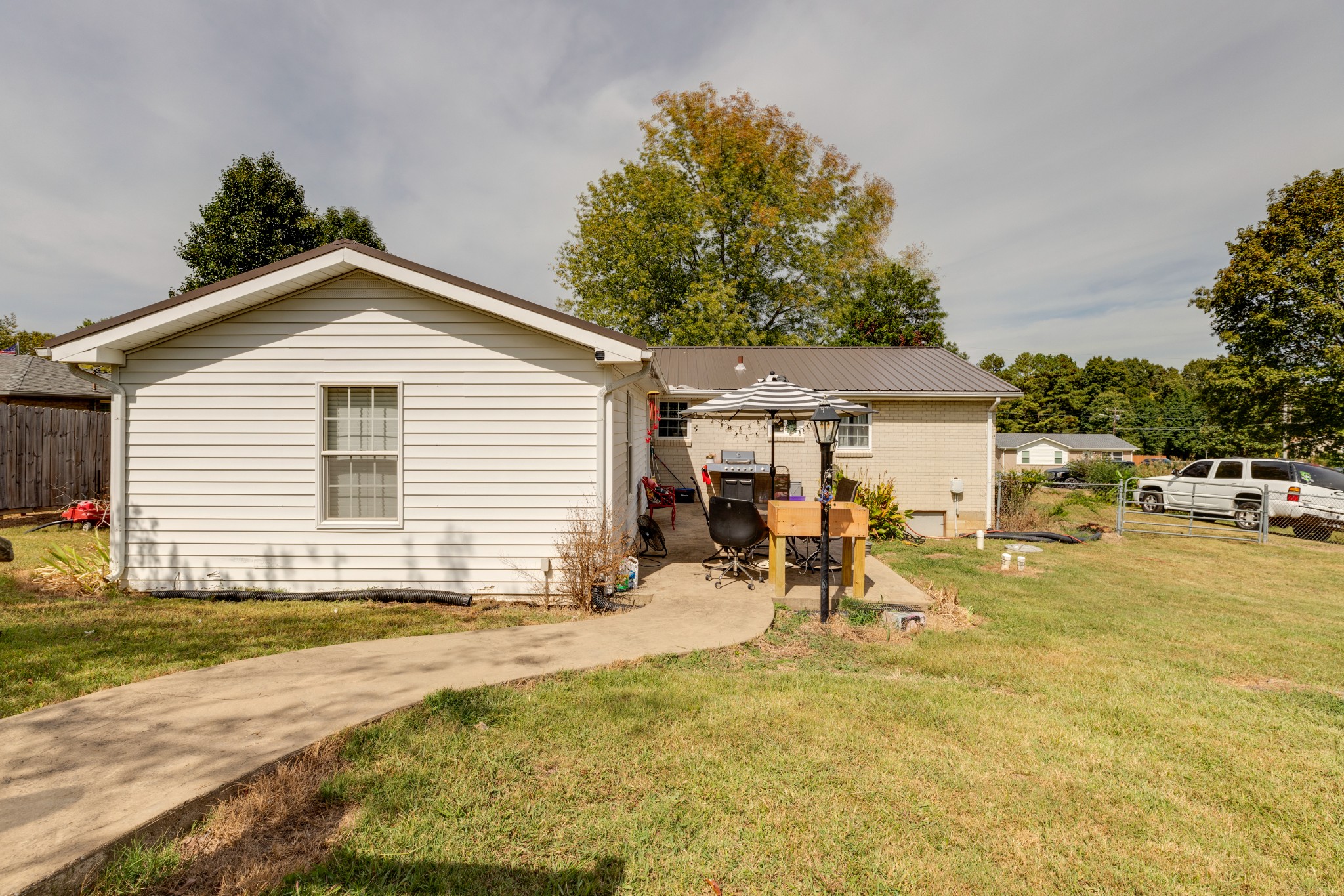 130 Mae Circle Dickson, TN 37055 - Photo 23 of 27 a view of a house with a backyard and a table and chairs