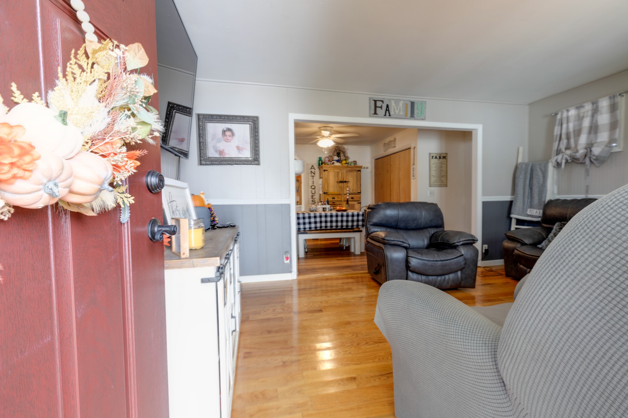 130 Mae Circle Dickson, TN 37055 - Photo 5 of 27 a living room with furniture a chandelier and a fireplace