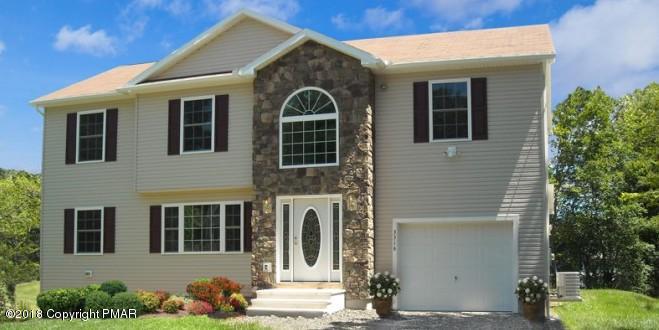 171 Magic Mountain Road Henryville, PA 18332 - Photo 1 of 2 a front view of a house with a yard