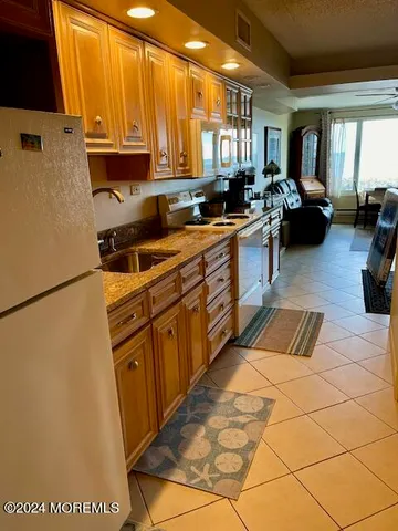 a kitchen with stainless steel appliances a refrigerator sink and cabinets
