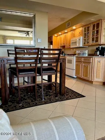 a kitchen with stainless steel appliances kitchen island granite countertop a stove a sink and a microwave