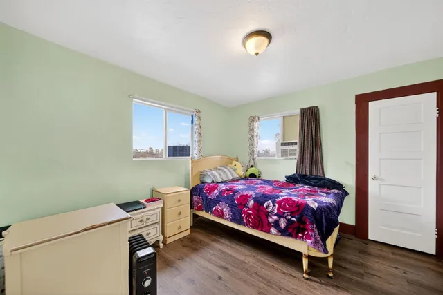 a bedroom with a bed and a window