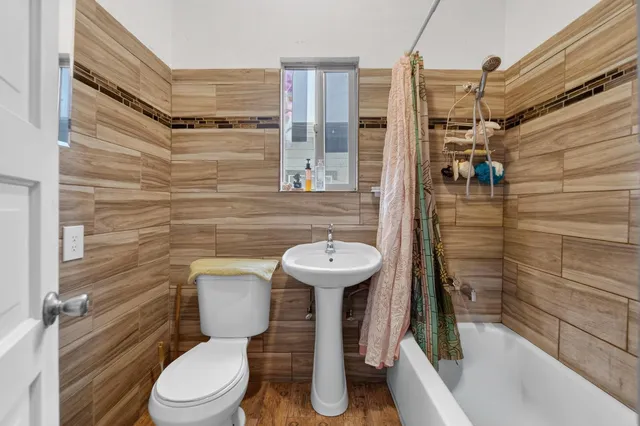 a bathroom with a toilet and a shower