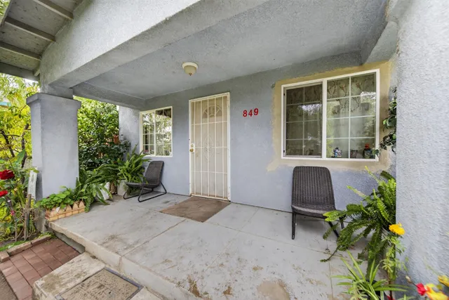 a porch with seating space and a potted plant