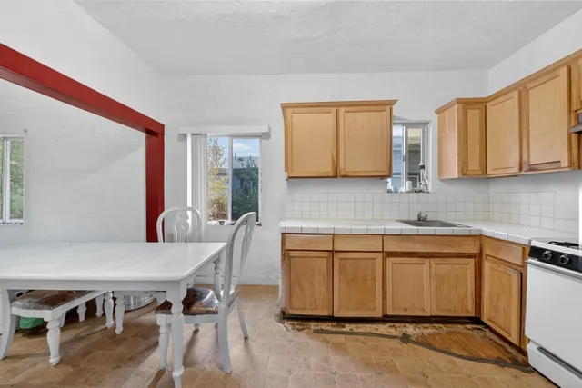 a kitchen with a table and chairs in it