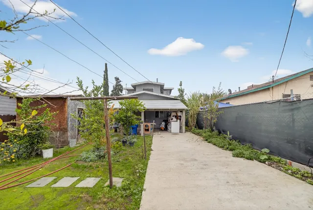 a view of a patio with table and chairs under an umbrella