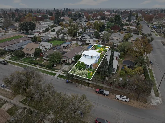 an aerial view of a house with a yard
