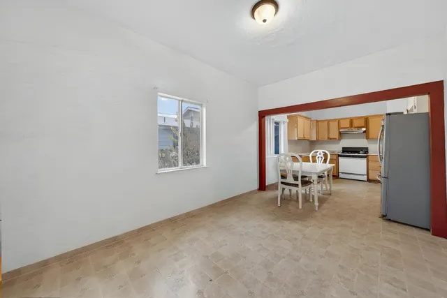 a dining room with furniture and a window