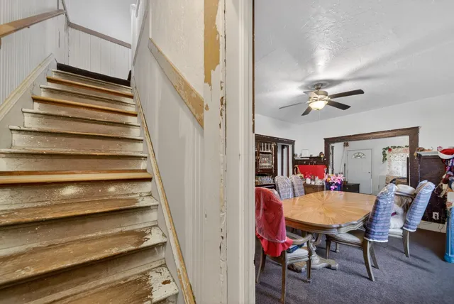 a view of a livingroom with furniture and staircase