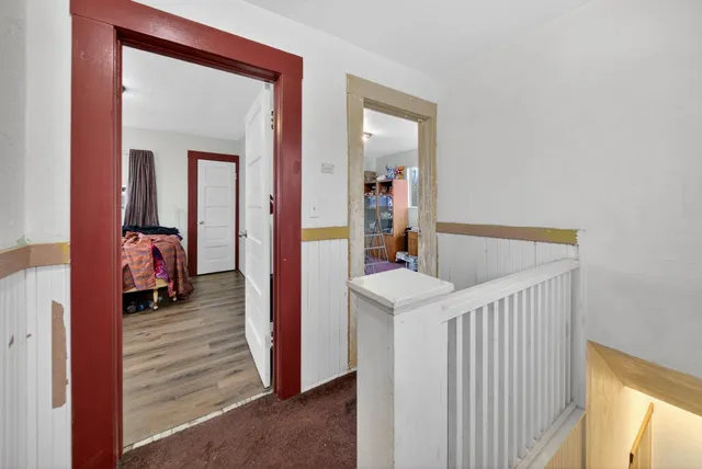 a view of a hallway to a livingroom with furniture