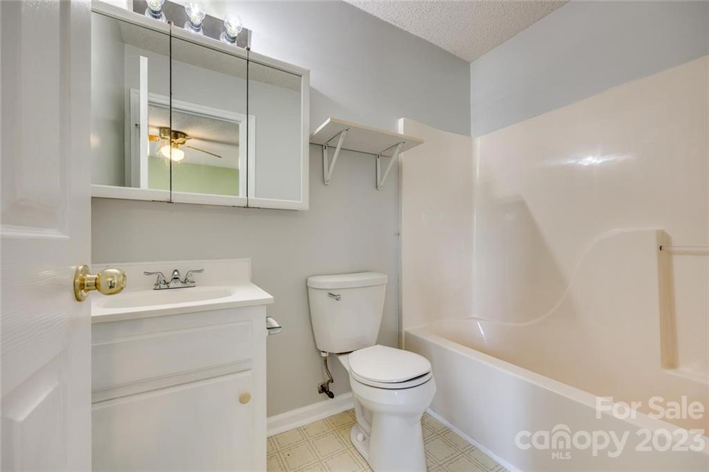 203 Brook Street Belmont, NC 28012 - Photo 16 of 17 a bathroom with a sink a toilet and a mirror