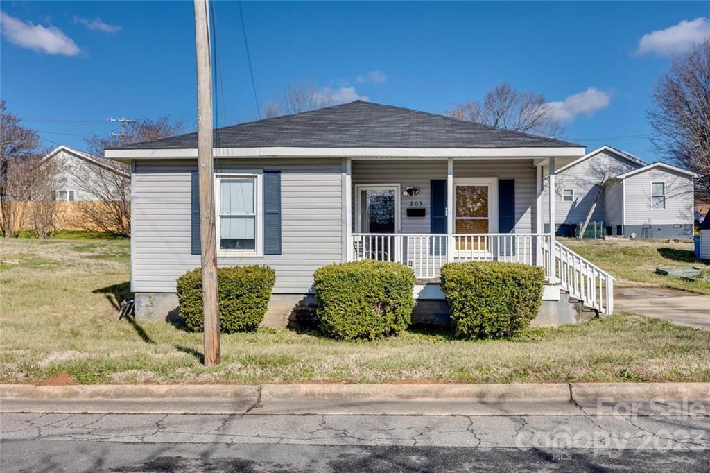 203 Brook Street Belmont, NC 28012 - Photo 2 of 17 a front view of a house with a garden