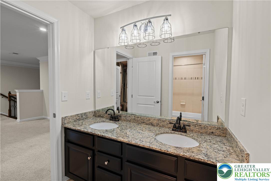 4758 Rafi Road Easton, PA 18045 - Photo 28 of 55 Double vanity with granite counters and rich cabinetry anchors this well-appointed bathroom.