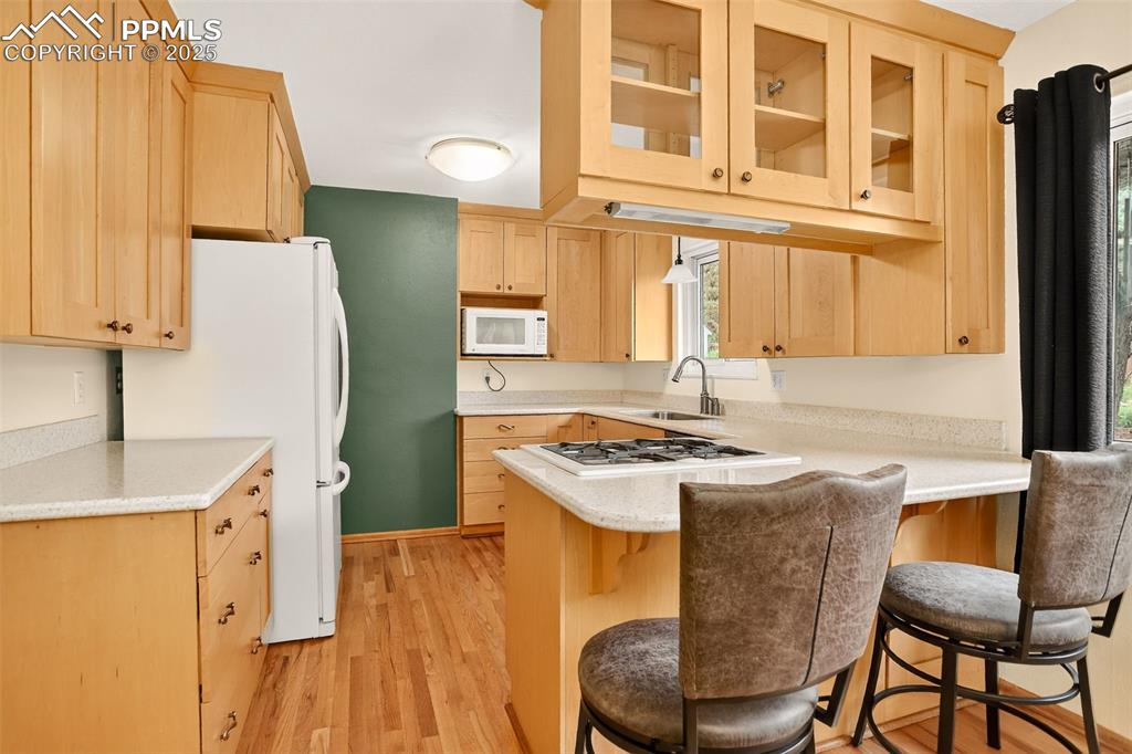 6035 Tuckerman Lane Colorado Springs, CO 80918 - Photo 14 of 47 a kitchen with a stove a refrigerator and a table