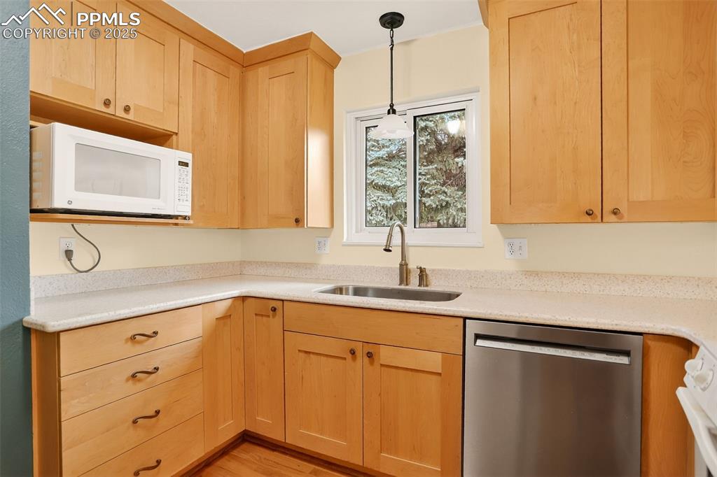 6035 Tuckerman Lane Colorado Springs, CO 80918 - Photo 16 of 47 a kitchen with stainless steel appliances granite countertop a sink a stove and cabinets