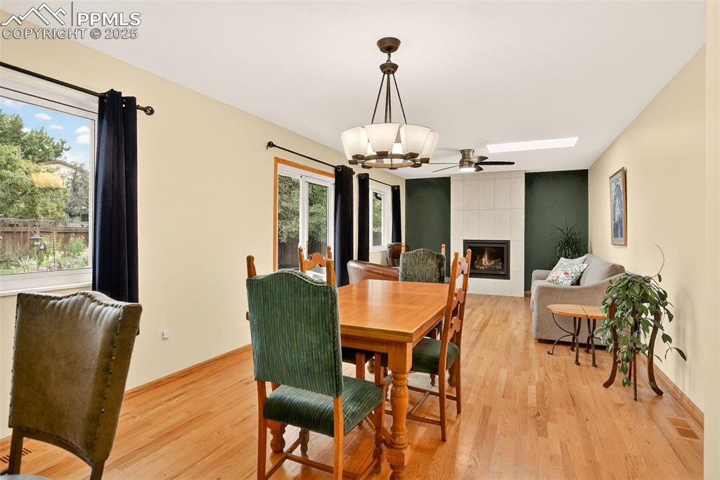 6035 Tuckerman Lane Colorado Springs, CO 80918 - Photo 17 of 47 a dining room with furniture a chandelier and wooden floor