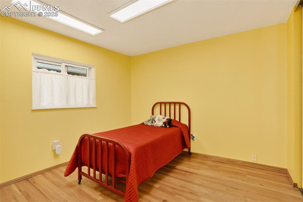 6035 Tuckerman Lane Colorado Springs, CO 80918 - Photo 27 of 47 a bedroom with a bed and a table