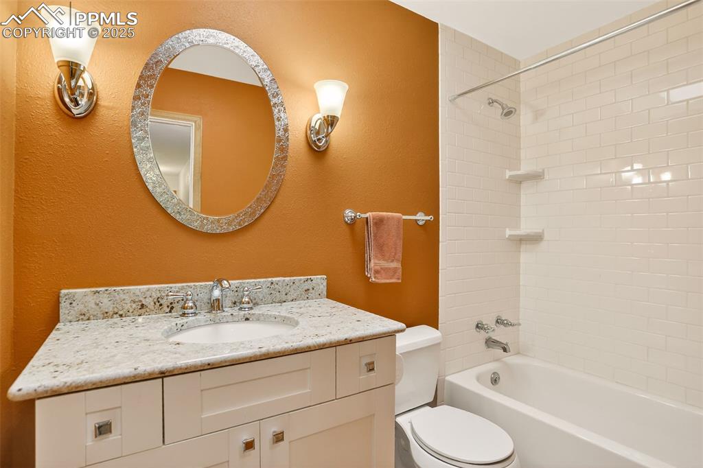 6035 Tuckerman Lane Colorado Springs, CO 80918 - Photo 30 of 47 a bathroom with a granite countertop sink toilet and shower