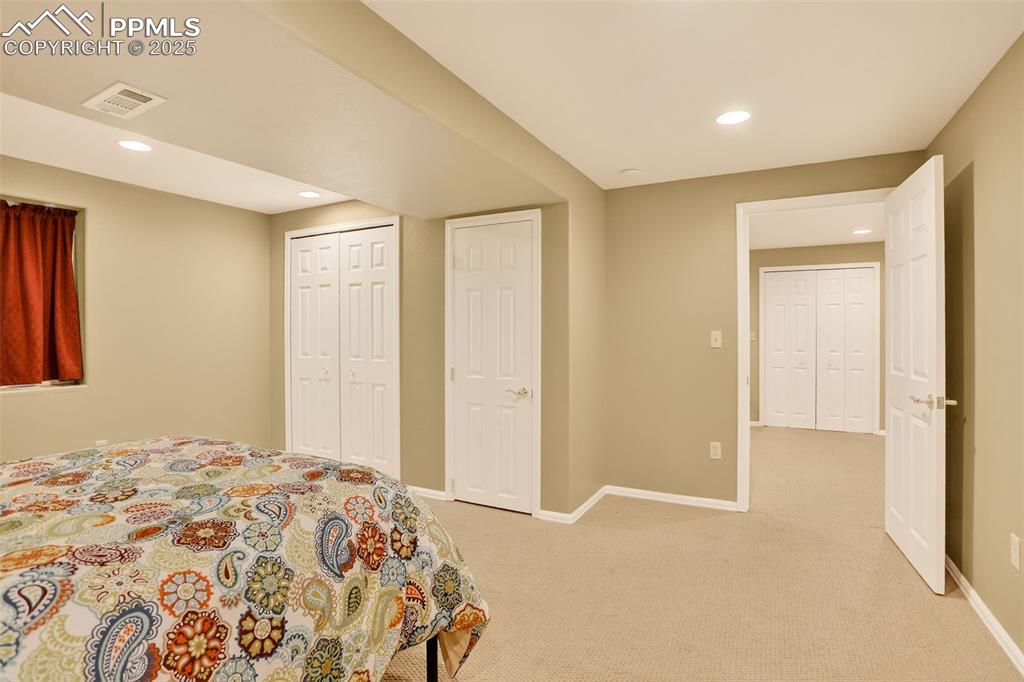 6035 Tuckerman Lane Colorado Springs, CO 80918 - Photo 35 of 47 a bedroom with a bed and a cabinets