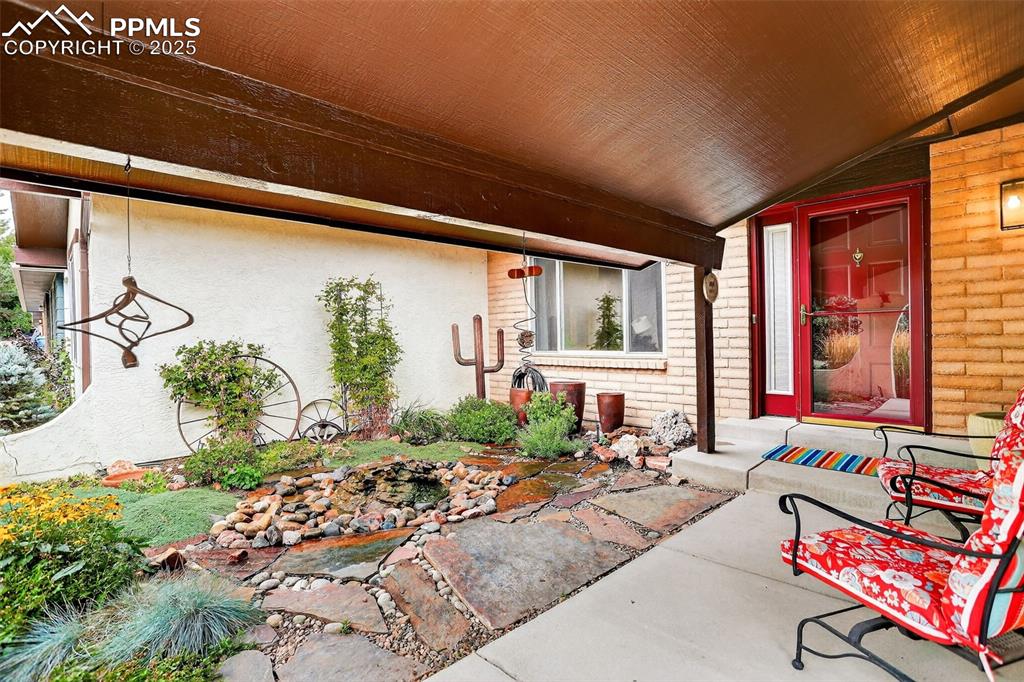 6035 Tuckerman Lane Colorado Springs, CO 80918 - Photo 8 of 47 a living room with patio furniture and a potted plant