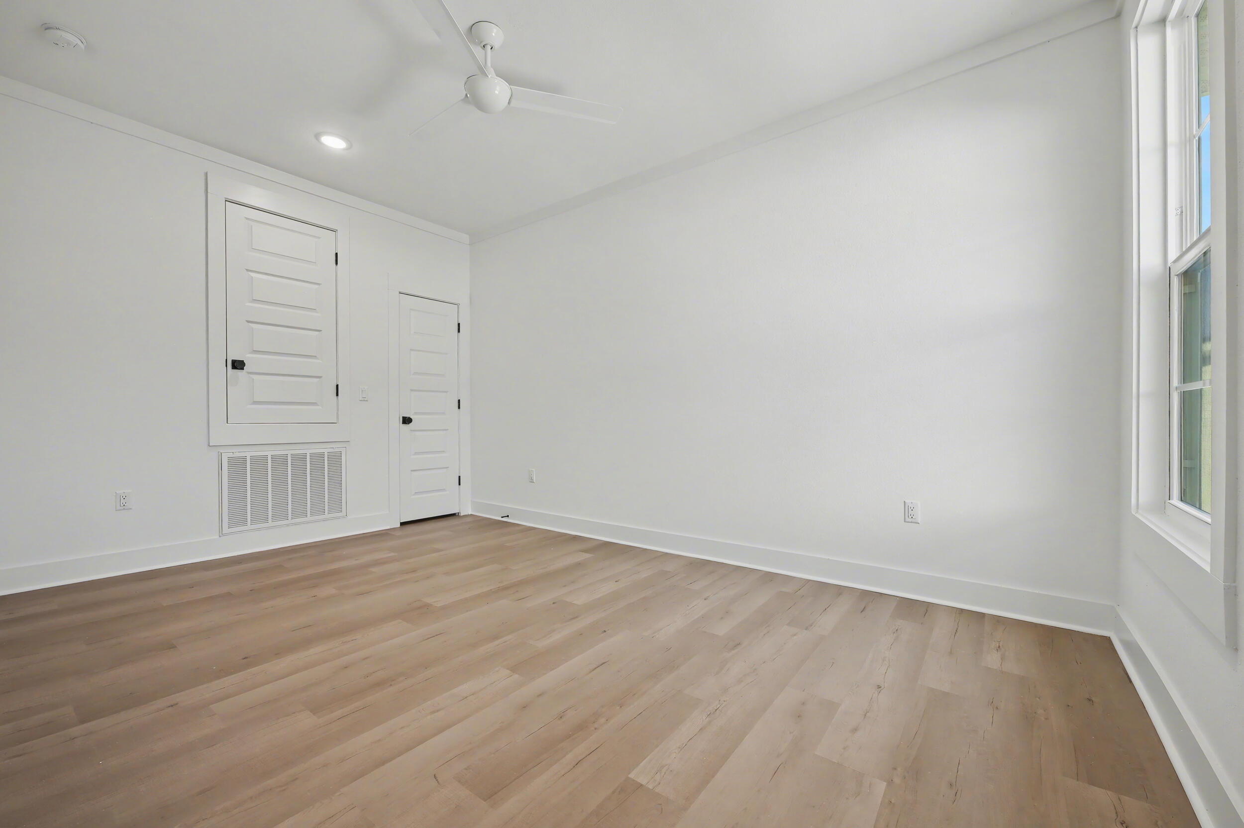 141 South H Street Pensacola, FL 32502 - Photo 22 of 30 wooden floor in an empty room with a window