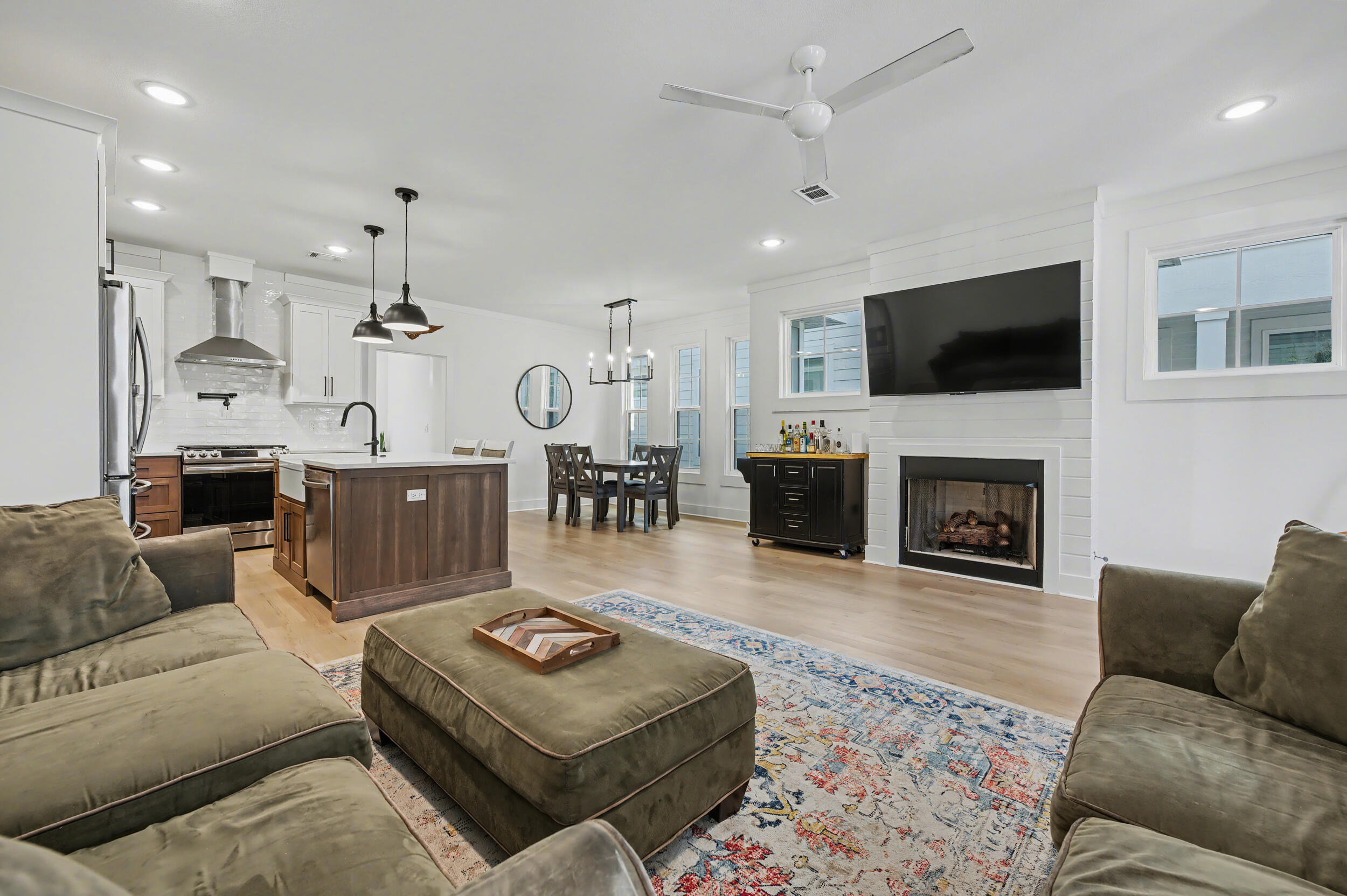 141 South H Street Pensacola, FL 32502 - Photo 3 of 30 a living room with furniture a flat screen tv and a fireplace
