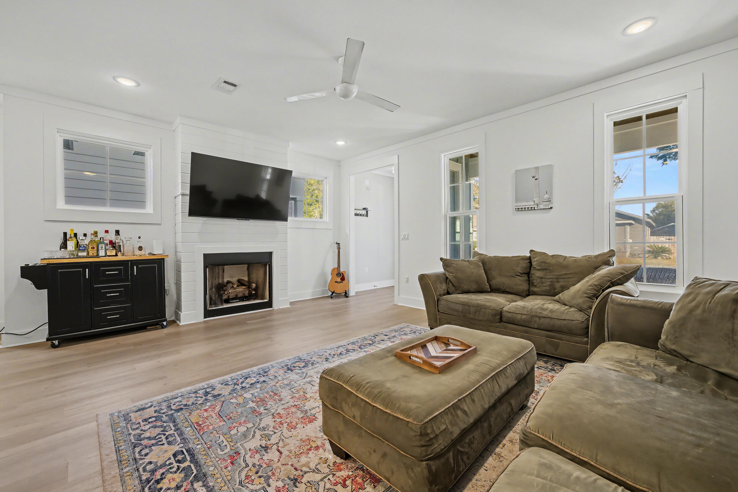141 South H Street Pensacola, FL 32502 - Photo 5 of 30 a living room with furniture a flat screen tv and a fireplace