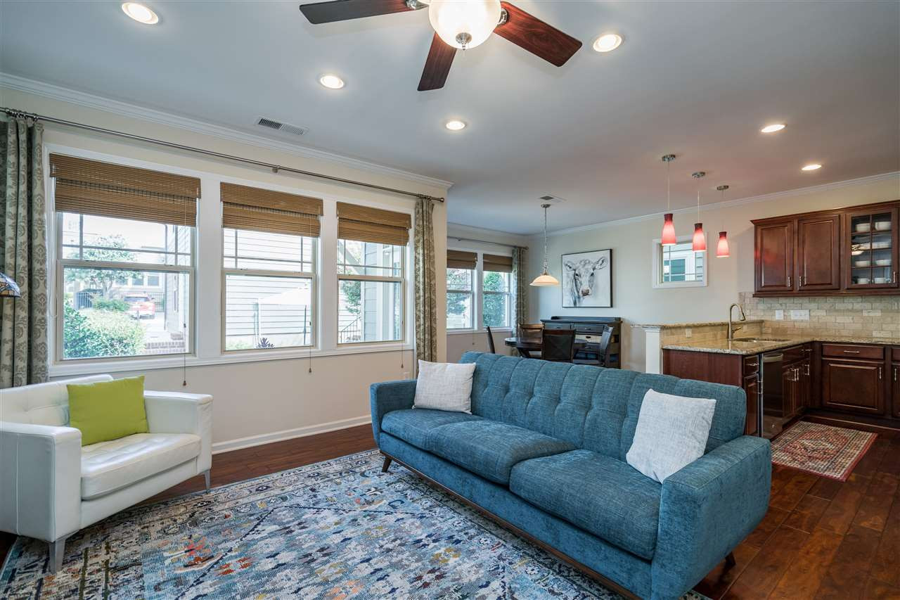 5630 Wade Park Boulevard Raleigh, NC 27607 - Photo 14 of 30 Living room features a gas fireplace, windows on both walls, hardwoods, fan, and recessed lighting! Living Room