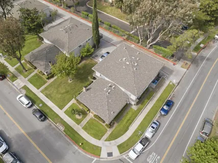 an aerial view of a house with a backyard