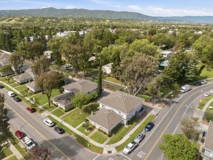 an aerial view of residential houses with outdoor space