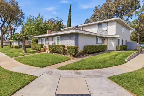 a view of a yard in front view of a house