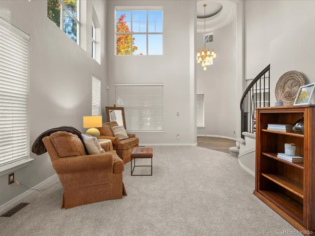 a kitchen with stainless steel appliances granite countertop a stove top oven a sink dishwasher a dining table and chairs with wooden floor