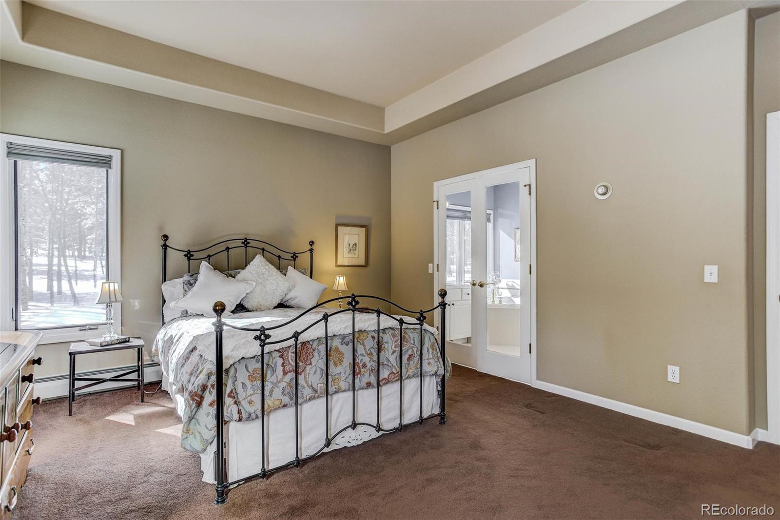 11800 South Ridge Road Conifer, CO 80433 - Photo 27 of 35 a bedroom with a bed and a window