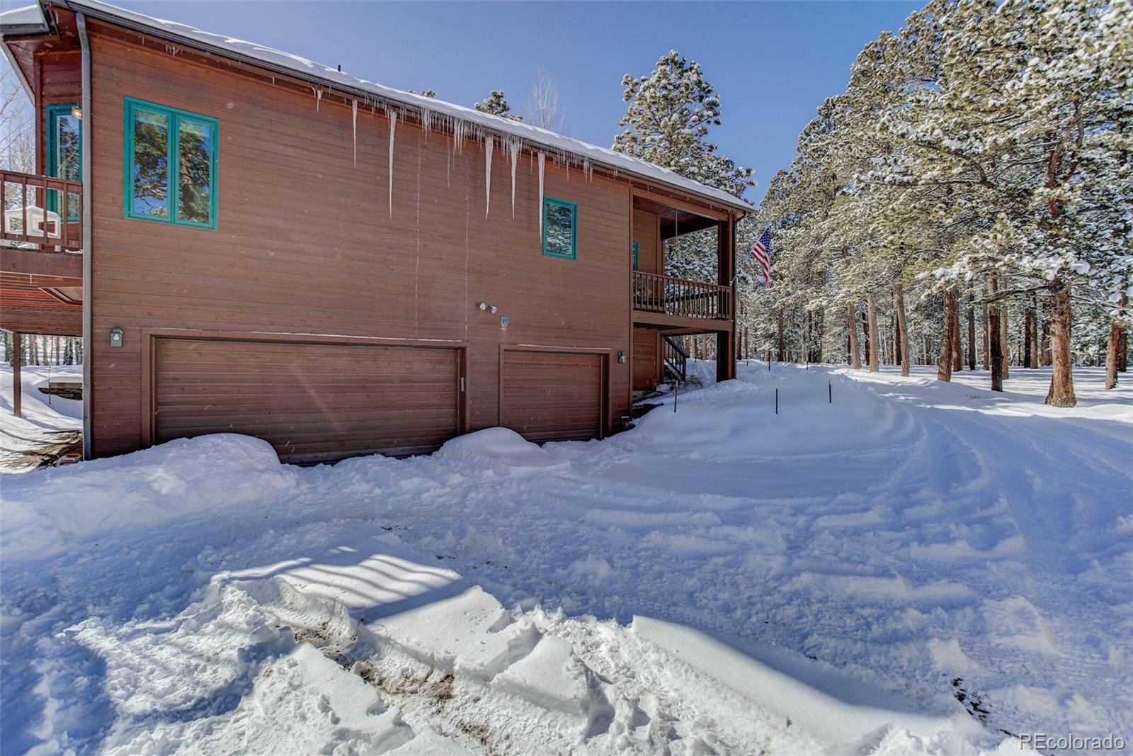 11800 South Ridge Road Conifer, CO 80433 - Photo 5 of 35 a front view of a house with a yard