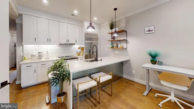 a kitchen with granite countertop white cabinets and stainless steel appliances