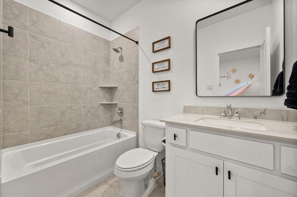 208 Scottish Way Mansfield, TX 76063 - Photo 28 of 38 Bathroom featuring vanity, bathtub / shower combination, and light tile patterned floors!