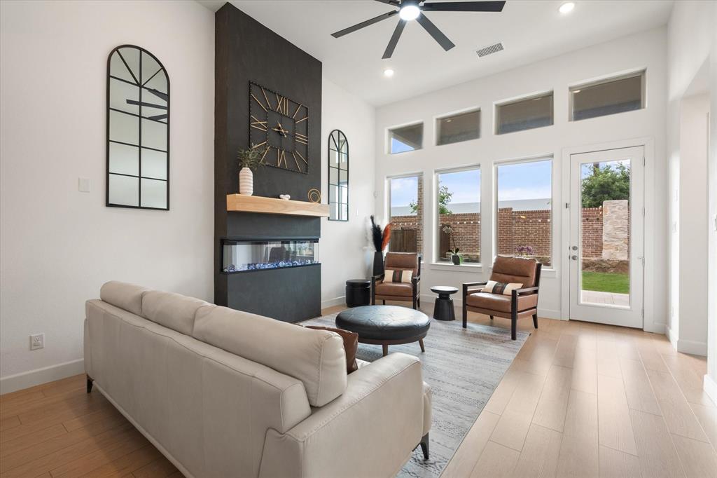 208 Scottish Way Mansfield, TX 76063 - Photo 3 of 38 Living area featuring floor to ceiling electric fireplace, ceiling fan and recessed lighting!